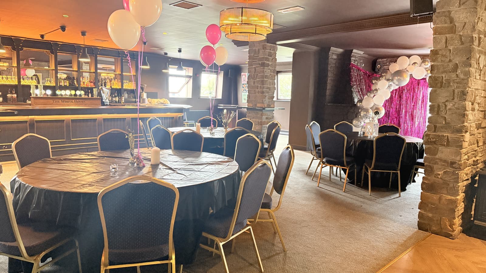 Function Room laid out for a party, with tables set and seating around the floor